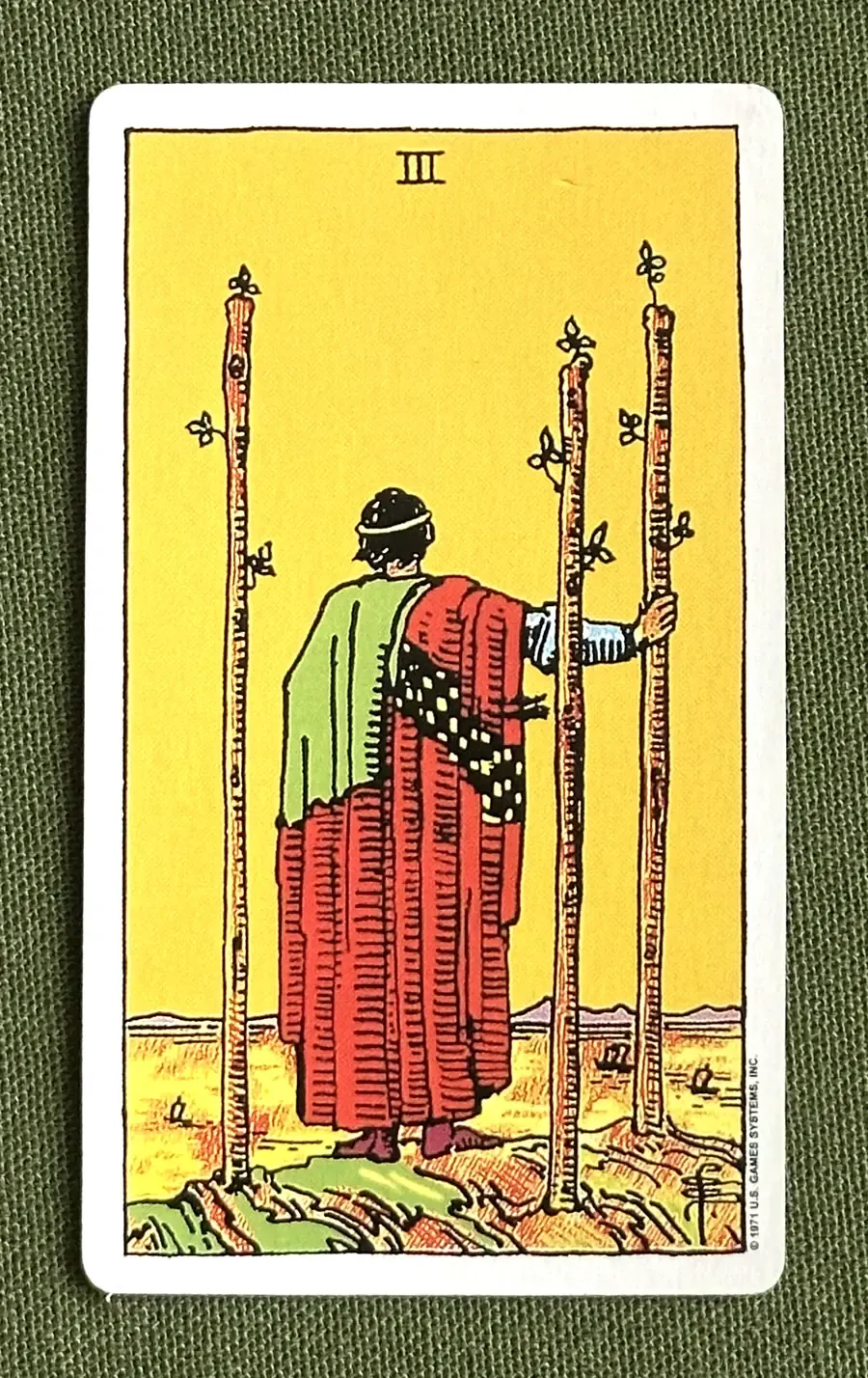 Three of Arrows — Three of Wands from the Rider–Waite deck